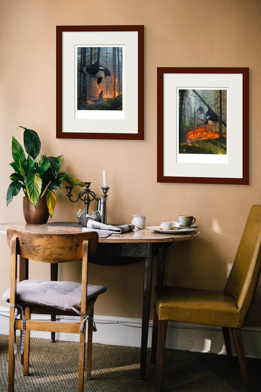 A cozy dining nook with a wooden table, two chairs, a potted plant, tableware, and "Dream and Lost," a signed and numbered Chris Austin diptych featuring animals and fire on a beige wall.