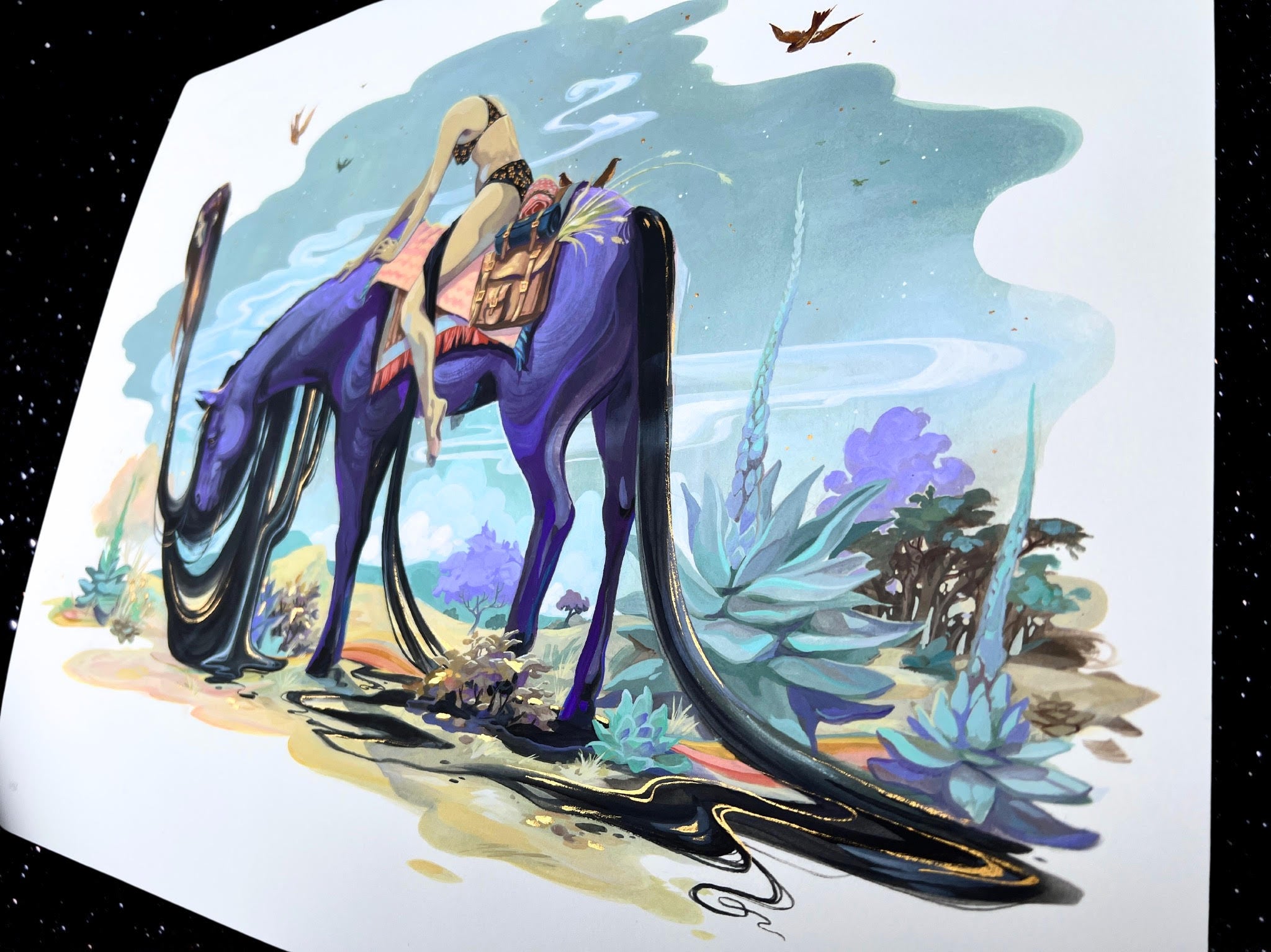 Lost At Twilight, a surreal archival pigment print by Audra Auclair, shows a person riding a long-necked, purple creature with black, flowing hair in a dreamy landscape of abstract plants beneath a sky where birds soar against a starry space backdrop.