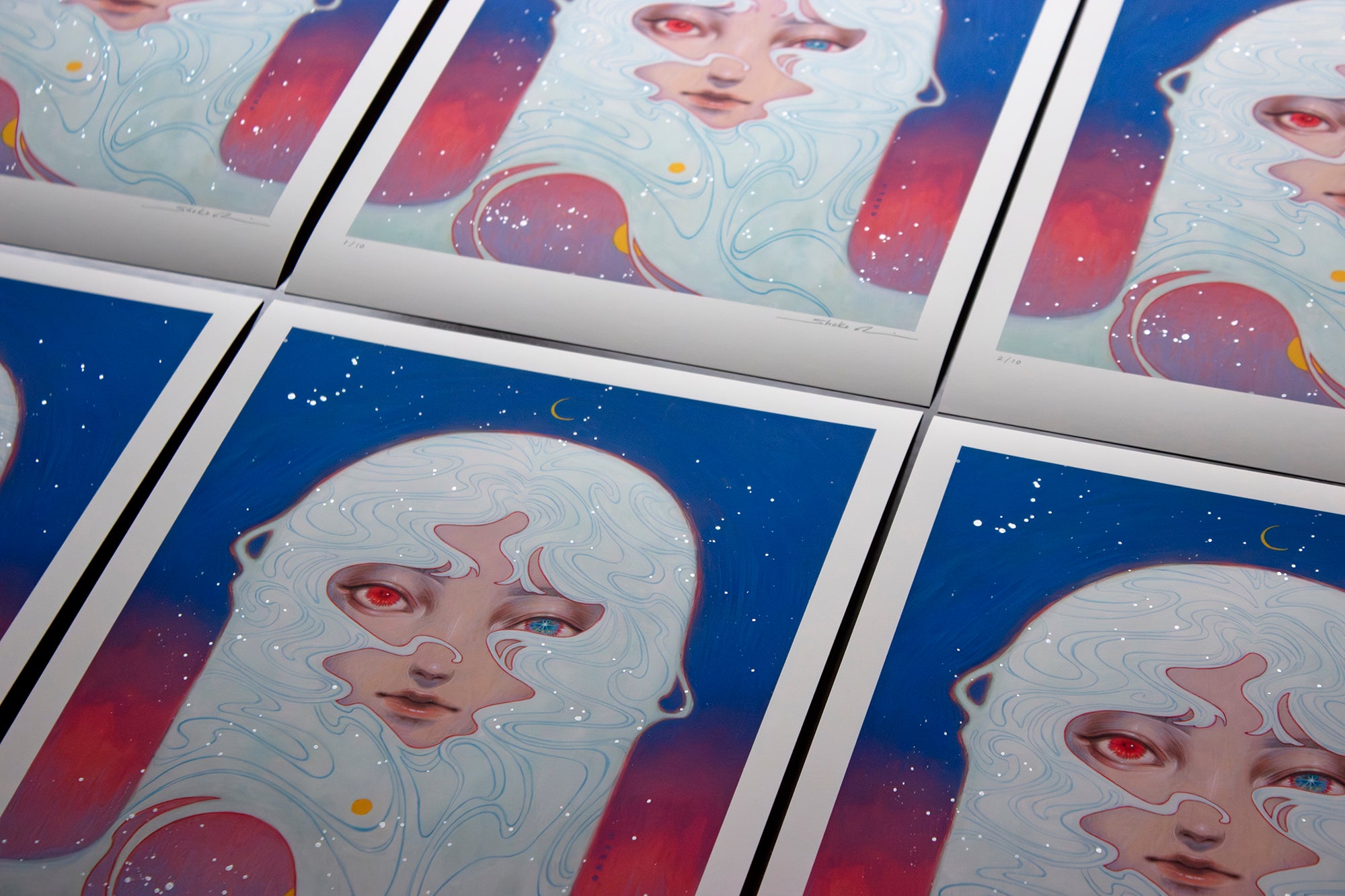 Discover Shoko Ishidas Melody of Dawn, a hand-embellished archival pigment print featuring a surreal face with flowing hair blending into a cosmic blue and red backdrop. Large, expressive eyes peer amidst stars and crescent moons.