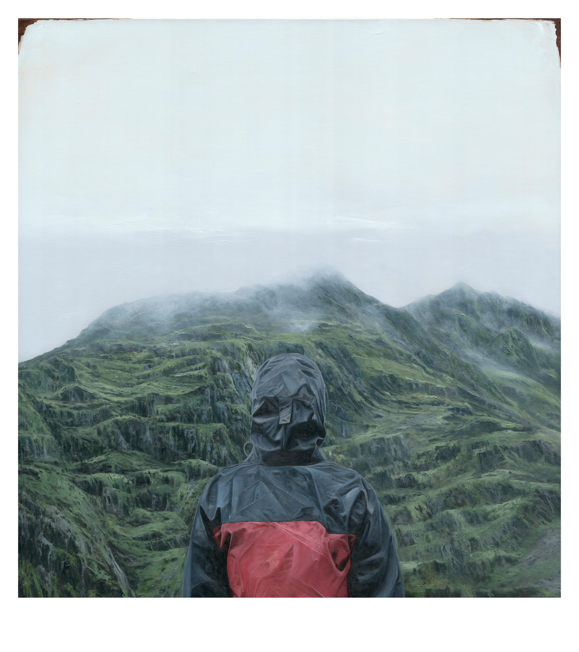 A person in a gray rain jacket with a red patch is captured facing misty, lush mountains under a cloudy sky. This exclusive edition archival pigment print, named Acclimation by Adam Hall, is limited to 50 signed and numbered pieces, emphasizing solitude and natural beauty.