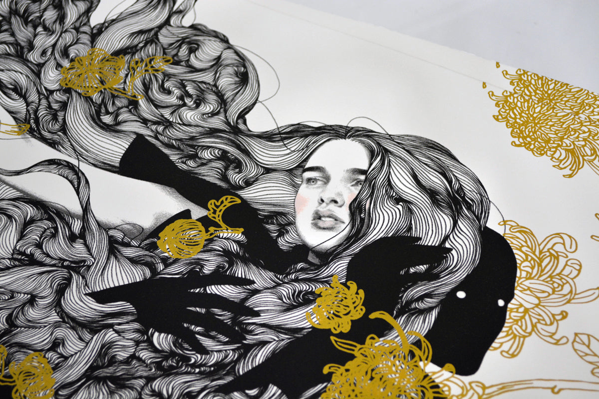 The Yellow Passerby & I by Tran Nguyen features a limited edition screenprint showing a serene face amid swirling black lines and golden flowers. Shadowy hands and abstract floral patterns add depth, with authenticity ensured by the artists signature on each piece.