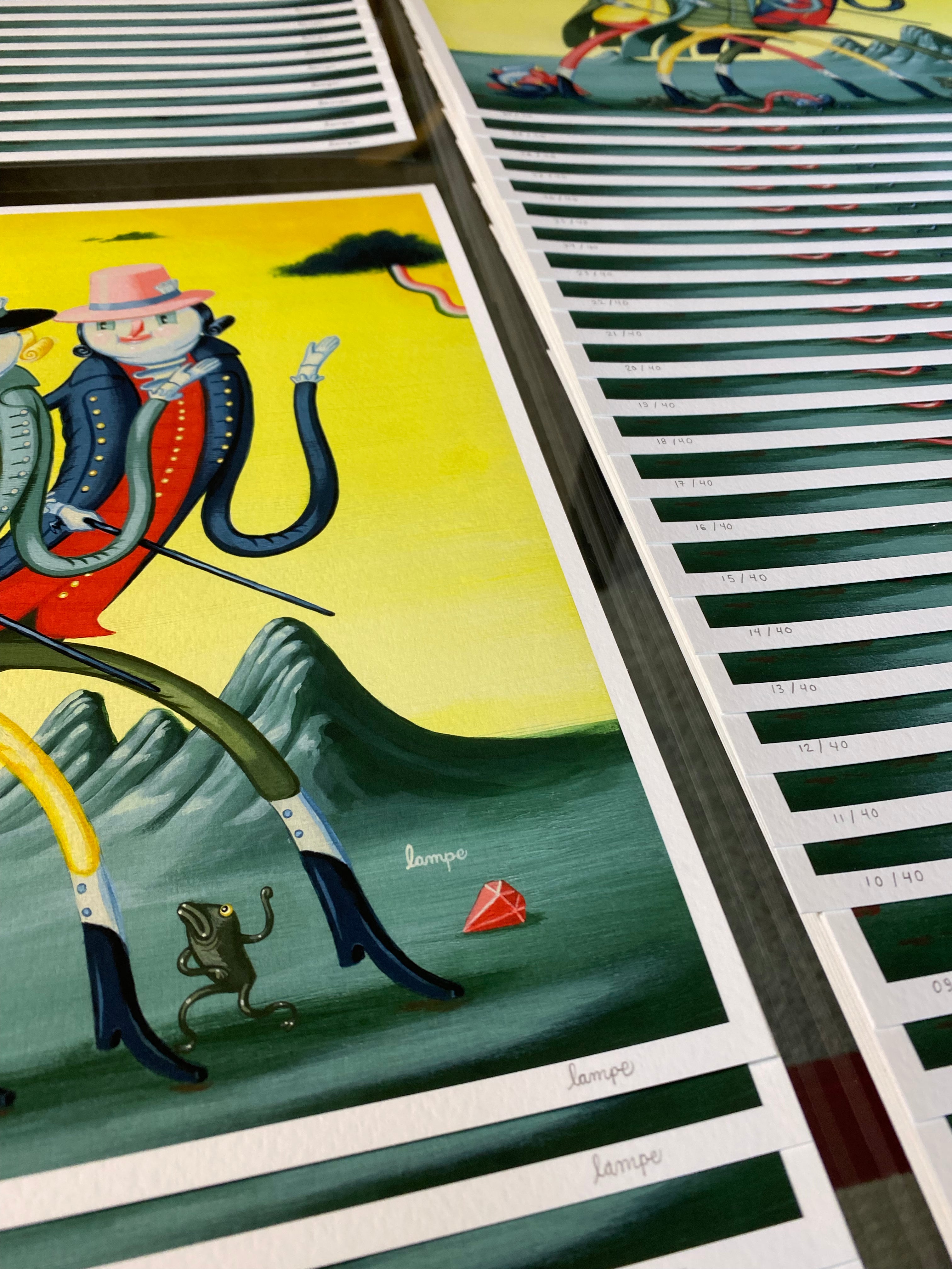 The Fancy Magicians, by Travis Lampe, presents archival pigment prints featuring a whimsical multi-armed figure in a pink hat near mountains. In the foreground, look for a small frog and red gemstone. Each colorful print is numbered and showcases unique artistry.
