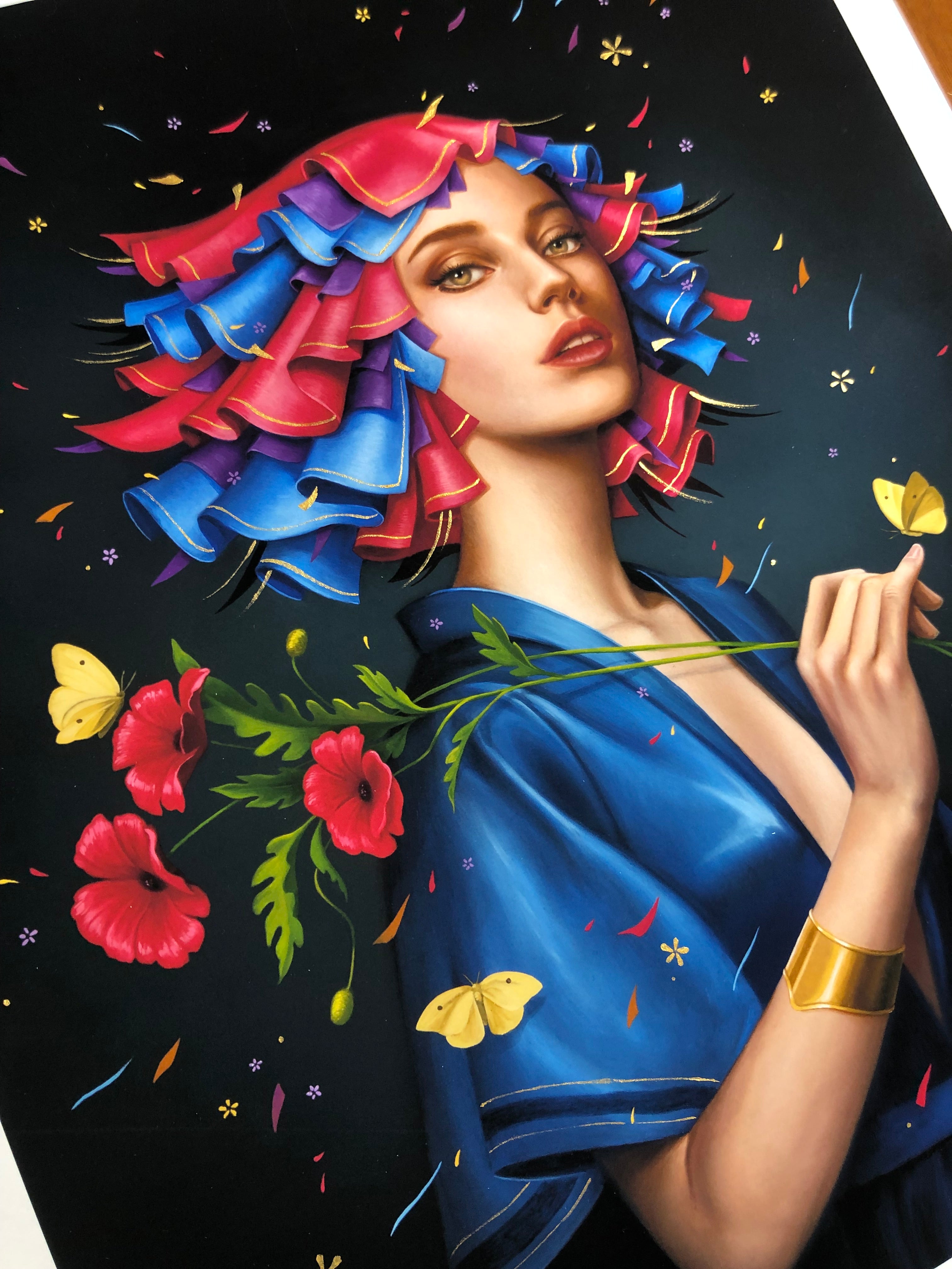 Allison Reimolds Poppy is a signed, numbered archival pigment print featuring a stylized woman with vibrant pink and blue curly hair wearing a blue dress. She holds red flowers amidst yellow butterflies on a dark background, accented with confetti-like dots. The piece is hand-embellished.