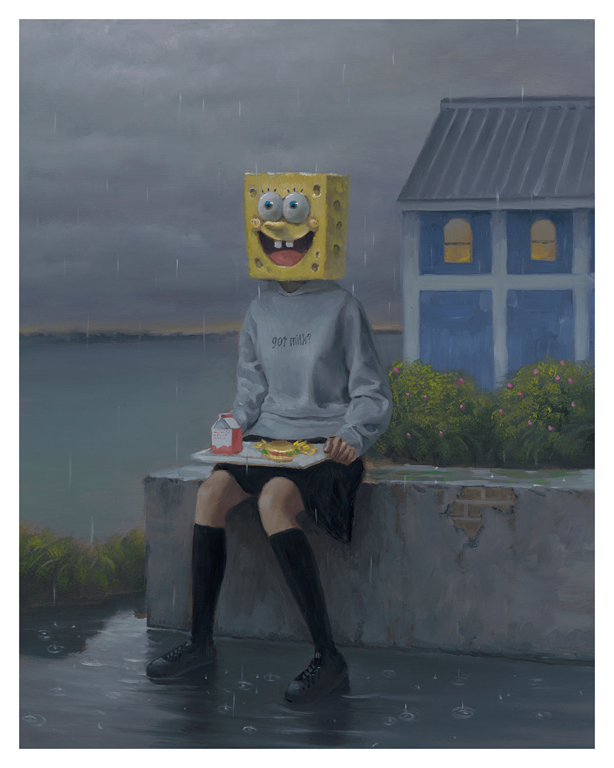 A person with a cartoon sponge head sits by the water under a gloomy sky, wearing a got milk? sweatshirt, shorts, and knee-high socks. They hold a carton and food tray. A blue house is in the background of Lunch Period, an archival pigment print signed and numbered by Leegan Koo.