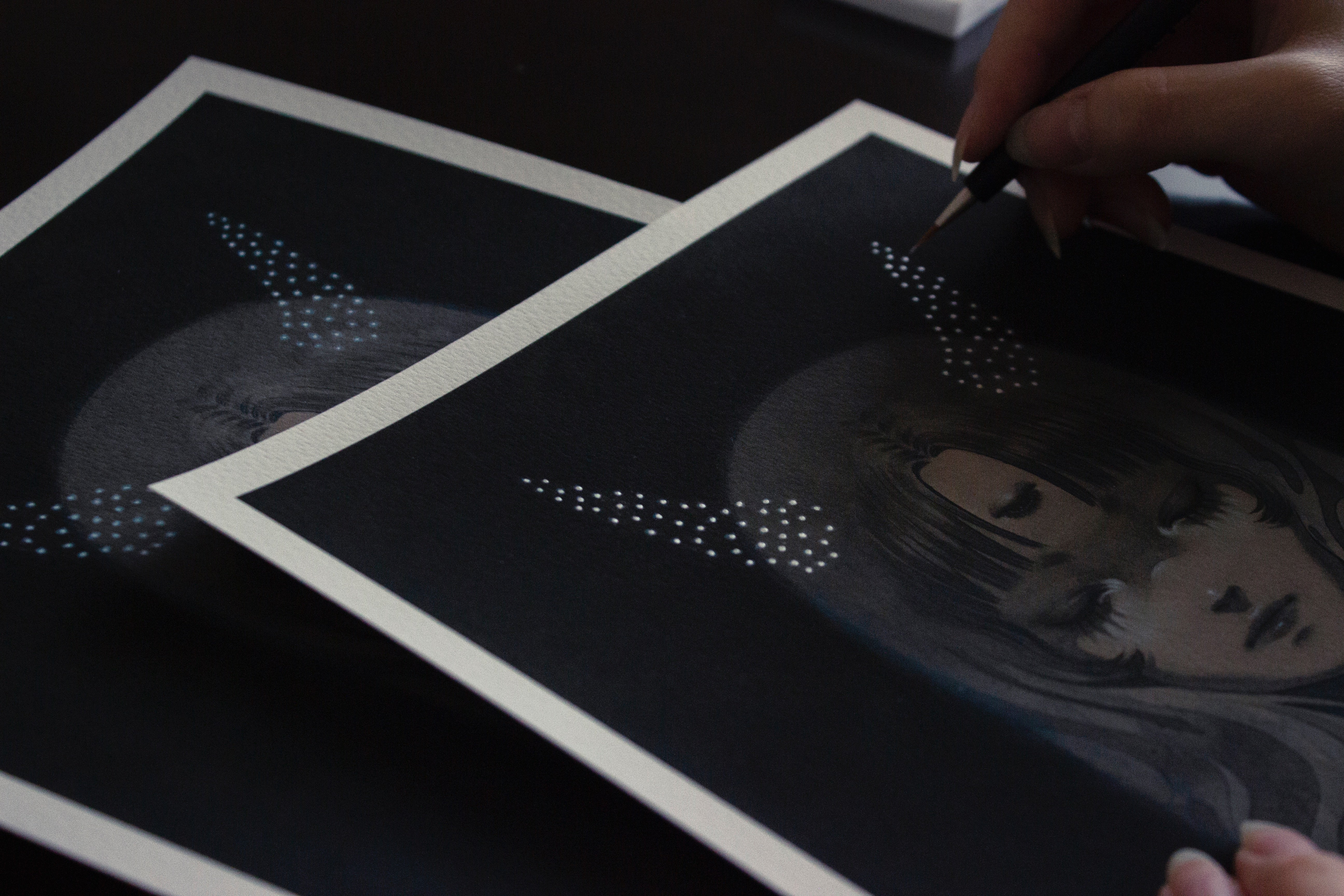 A person draws an anime-style portrait titled Stardust Slumber on black paper. One finished and one pencil-refined rendition evoke an ethereal glow reminiscent of Shoko Ishidas archival pigment prints.