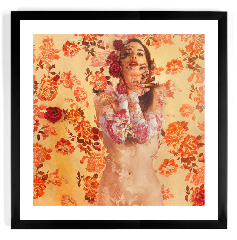 The limited edition archival framed artwork Jaquenetta by Sergio Lopez features a woman with floral patterns seamlessly blending into her skin and surroundings, standing amidst vibrant red and orange flowers on a warm yellow-toned surface, creating a dreamy effect.