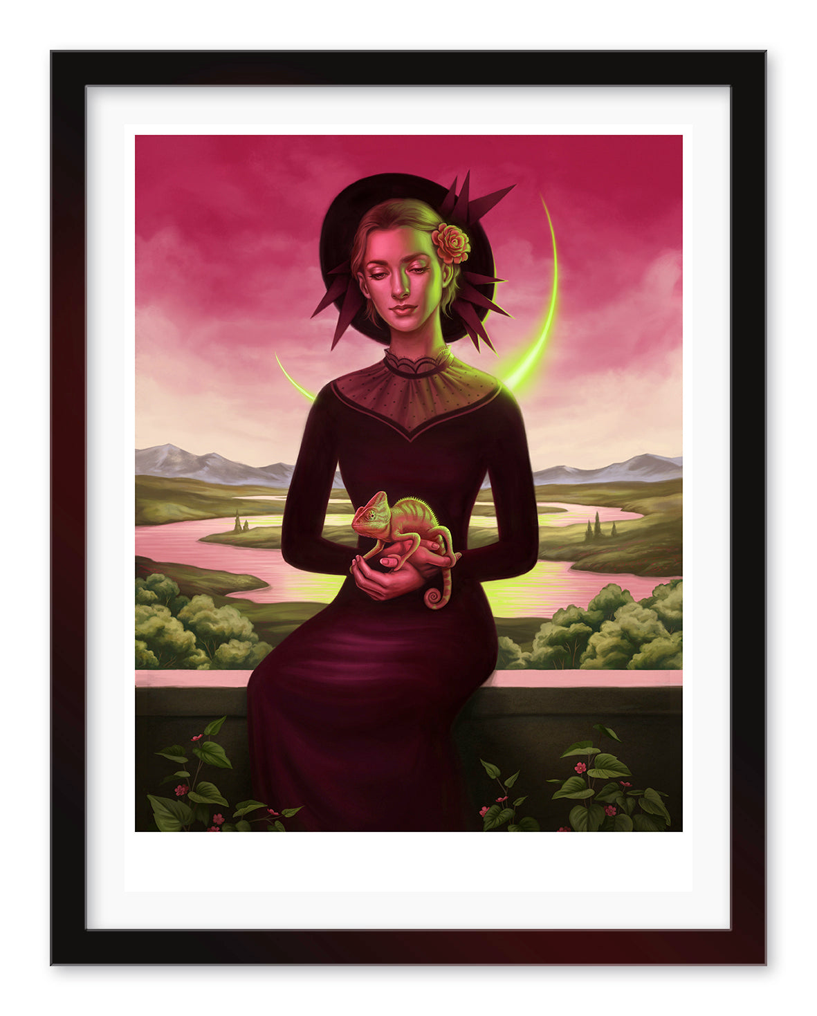 In the Allison Reimold archival pigment print Neon Madonna, a woman in a dark dress holds a chameleon, set against a scenic landscape with a crescent moon and pink sky. She features a halo-like headdress, flower in her hair, and plants adorning the foreground.