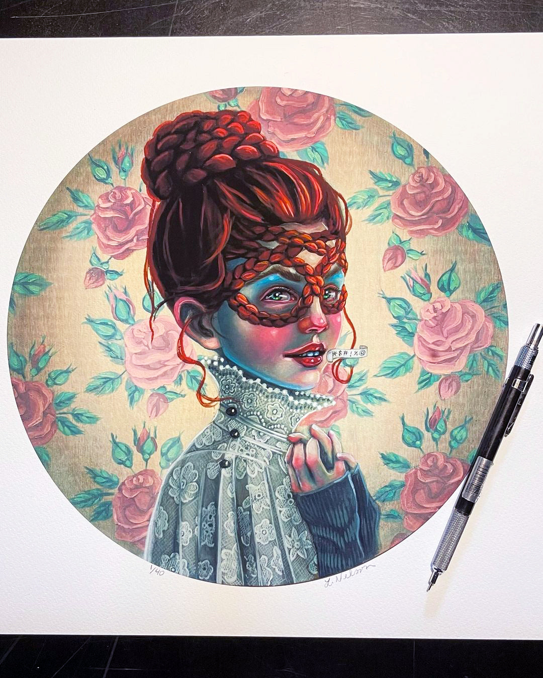 The artwork Profanatine by Lori Nelson showcases a woman with red hair in a braided updo, wearing a lace top and floral mask, holding a Ceres label near her lips. The background is large pink roses on beige. It comes as a signed and numbered edition of 40 archival pigment prints with a pen beside it.