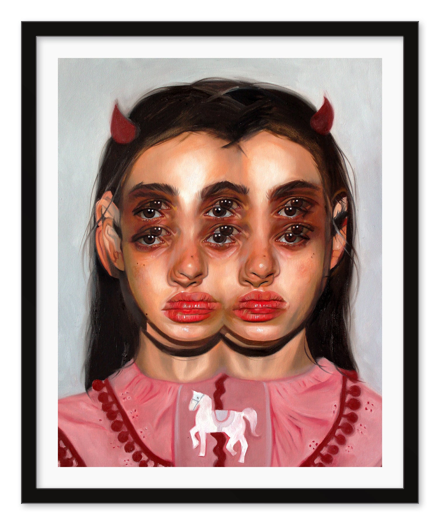 The Carousel portrait by Alex Garant showcases a girl with long dark hair in a pink dress with a carousel horse, featuring four eyes, two noses, and two mouths. Adorned with small red horns, this surreal piece is set against a plain backdrop and elegantly framed in black.