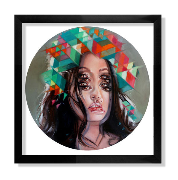 A framed fine art giclee print titled Kaleidoscope by Alex Garant showcases a surreal portrait of a woman with multiple eyes and lips, creating a kaleidoscope effect, complemented by colorful geometric shapes forming her headdress.
