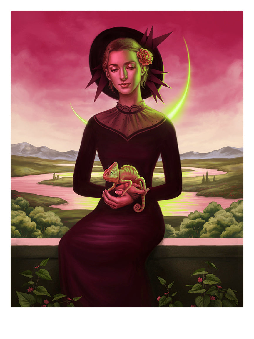 A woman in a dark dress and crescent-rimmed hat, akin to a Neon Madonna, cradles a chameleon against pink skies with mountains and rivers. Green foliage with pink flowers enhances the vibrant landscape of this archival pigment print by Allison Reimold.