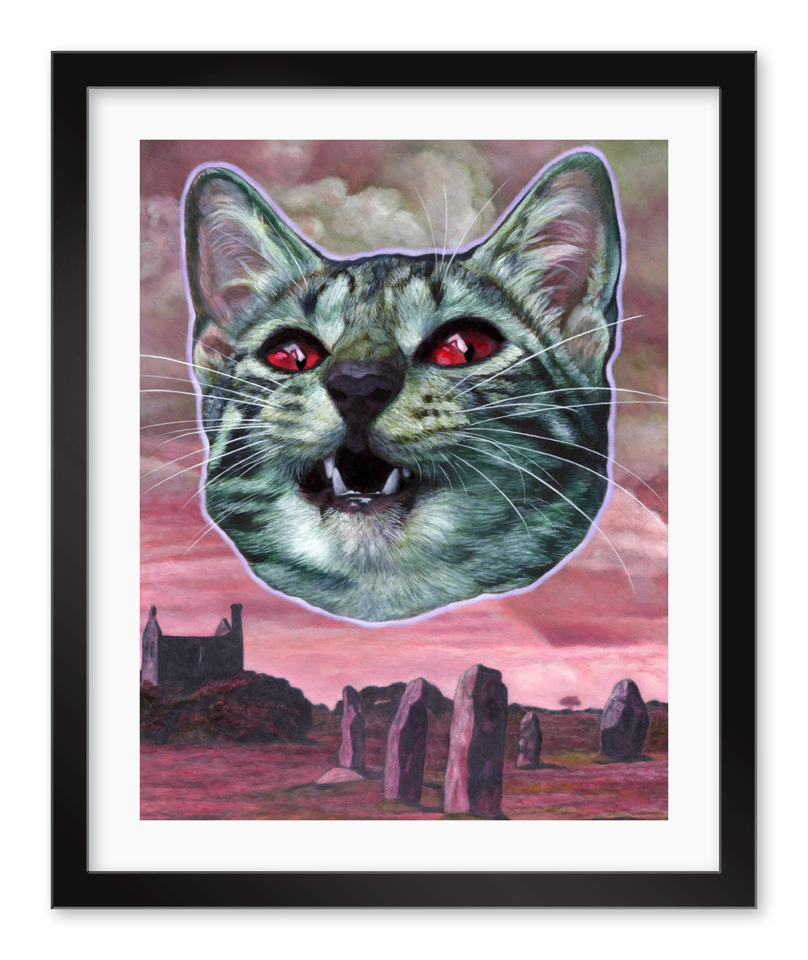 The Kittening by Johannah ODonnell is an archival pigment print featuring a large cat head with red eyes set against standing stones and a building under a cloudy pink sky, framed in black.