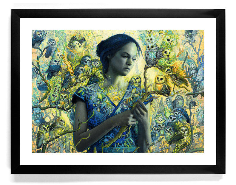 “Spark” by Rod Luff features a woman in a blue dress amid intricate, colorful owls and tree branches, serene and dreamlike—available as a limited edition fine art giclee print, framed in black.