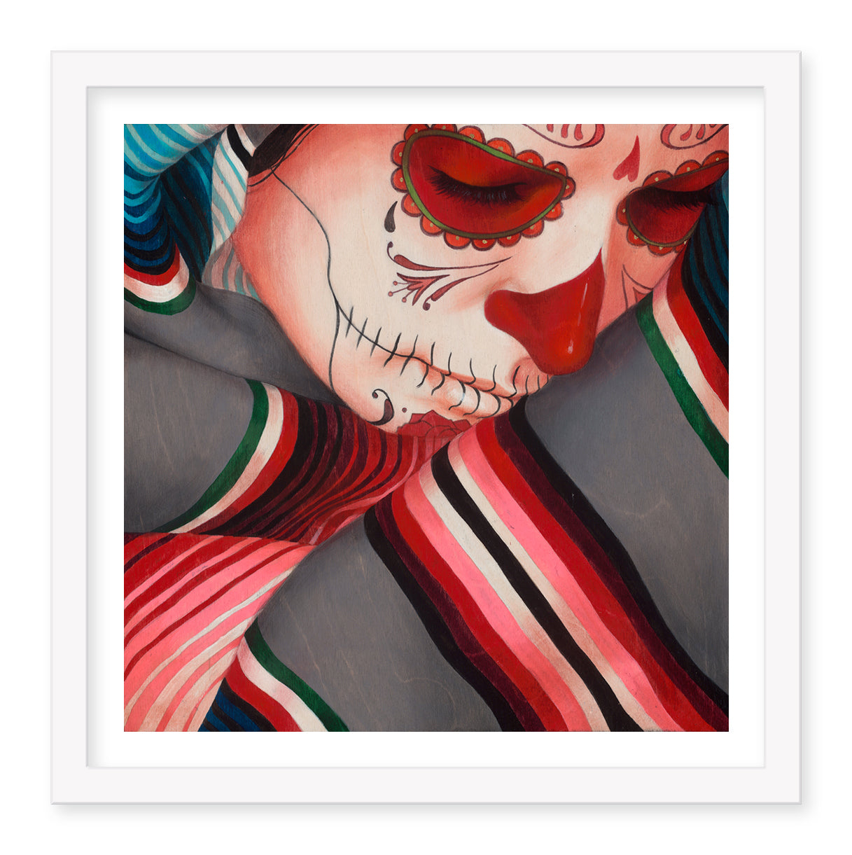 The Sylvia Ji Serape, Grey (Artists Proof) fine art print features a person with a sugar skull face, detailed in red and black designs. Wrapped in a vibrant serape, their closed eyes evoke an introspective atmosphere emblematic of Sylvia Jis iconic style.