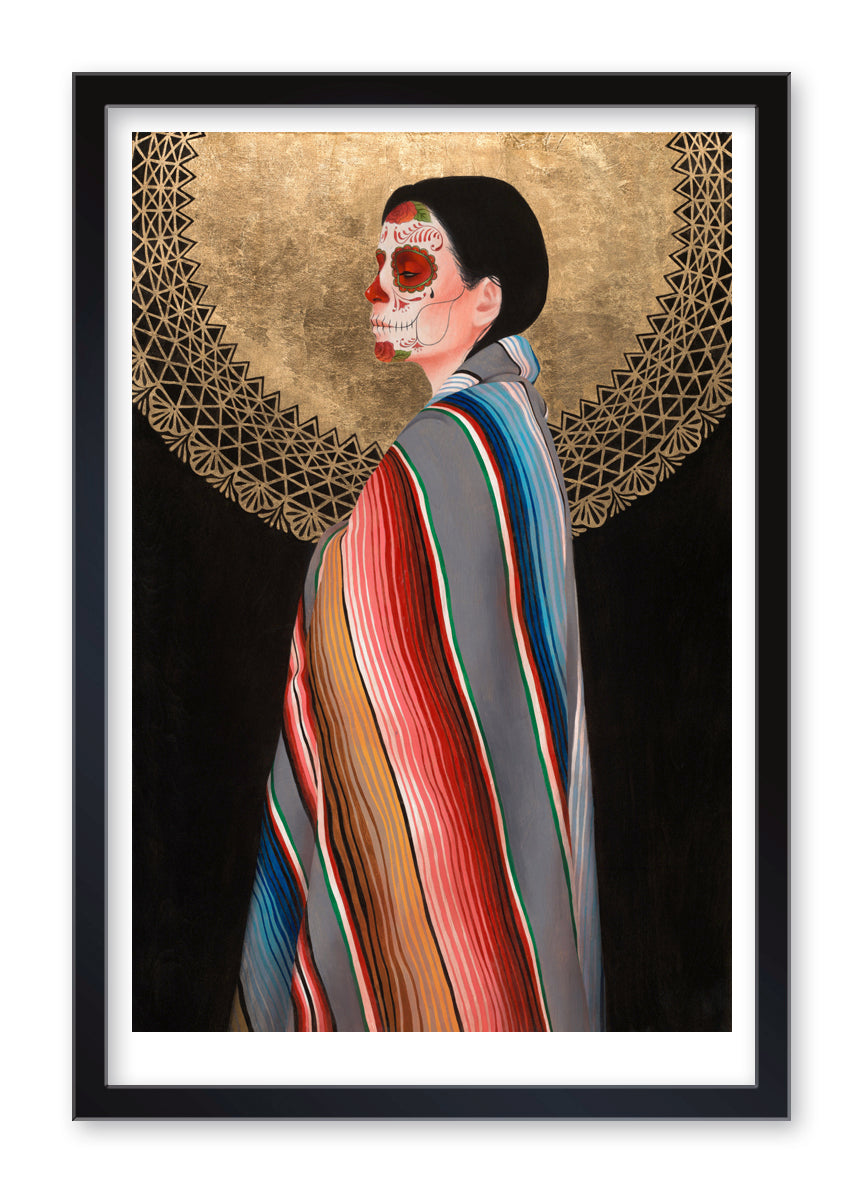 Sol de Oro" (Artist's Proof) by Sylvia Ji depicts a woman in profile, her face painted like a sugar skull, draped in a vibrant striped shawl before a golden Sol de Oro pattern on black, presented in an elegant black frame.