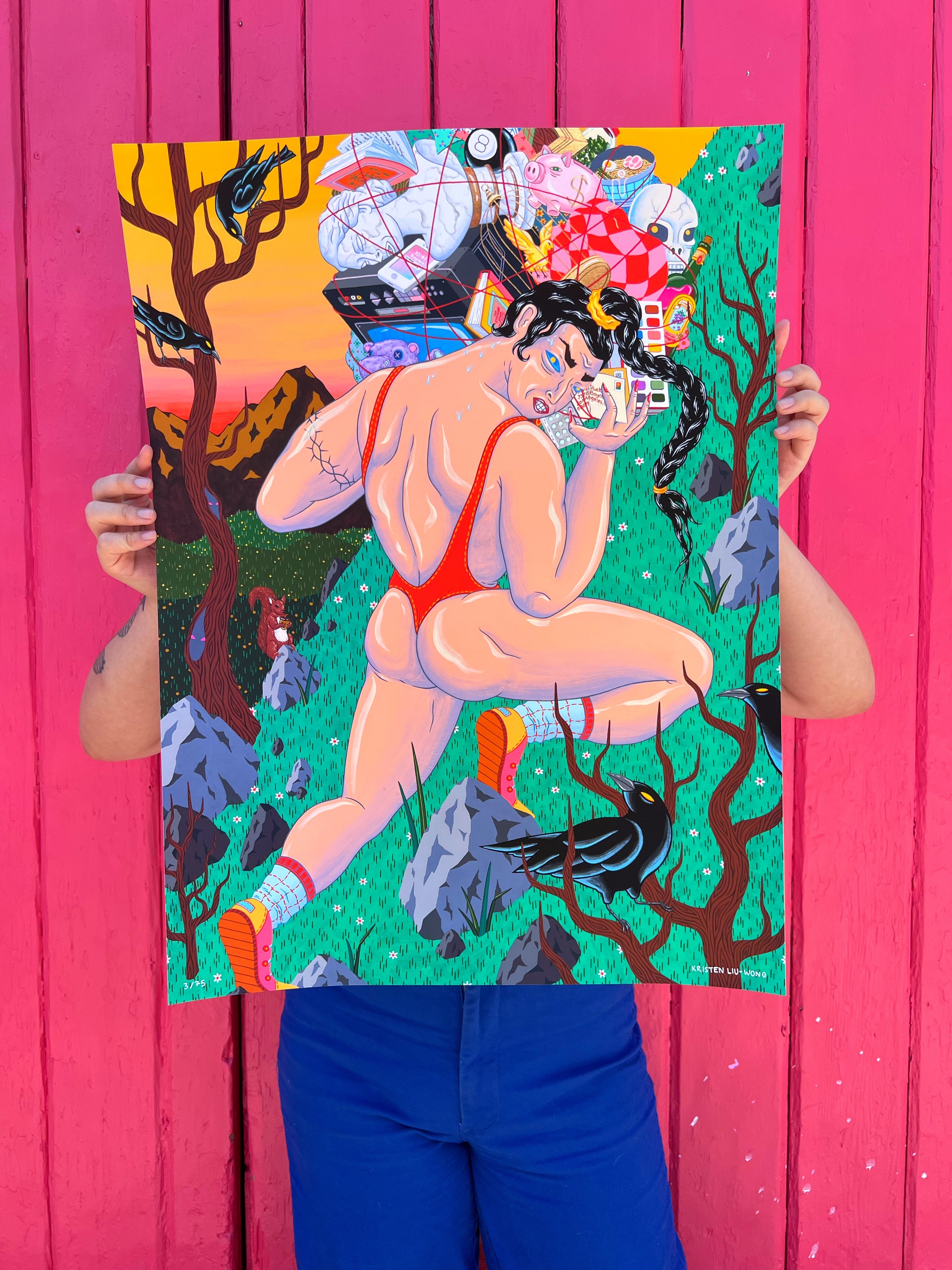Someone showcases The Burden by Kristen Liu-Wong—an archival pigment print of an exaggerated figure in a red swimsuit surrounded by fantastical scenery—against a vivid pink wooden wall, while wearing blue pants, creating an eye-catching tableau.