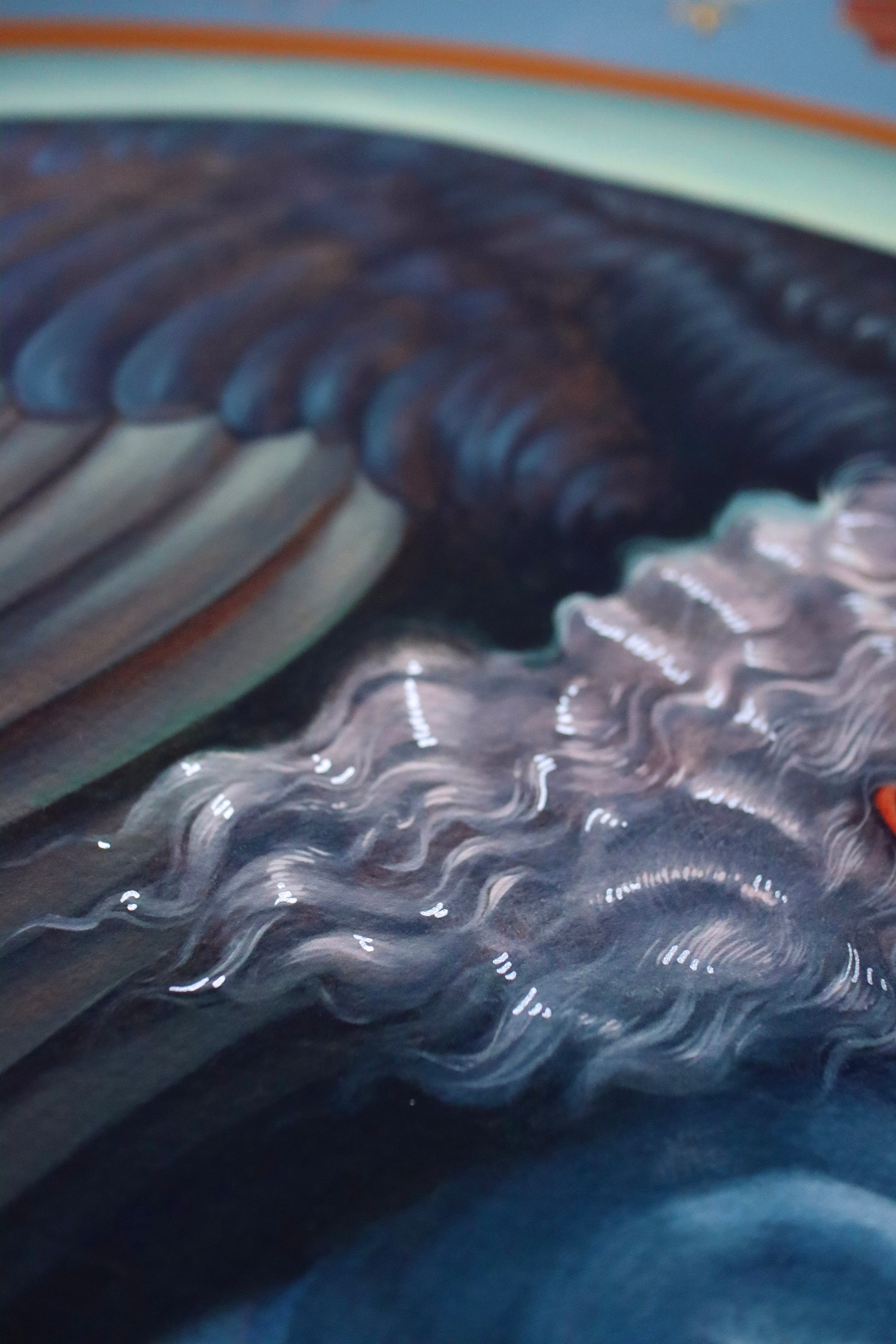 Close-up of A Hearts A Heavy Burden by Ruth Speer, displaying abstract dark blue and light gray waves with orange hints. This archival pigment print features a smooth, shiny texture mimicking flowing water or hair, creating an exquisite hand-embellished edition.