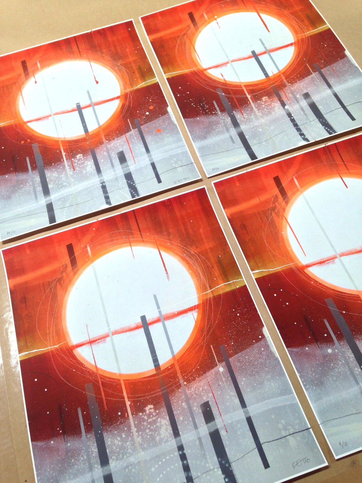 The What Shall Be Shall Be collection by Erik Otto includes four abstract prints with a large white circle among orange and red colors. Black vertical lines and scattered white specks transition to gray. Each signed, numbered, and hand-embellished fine art giclee print showcases this design.