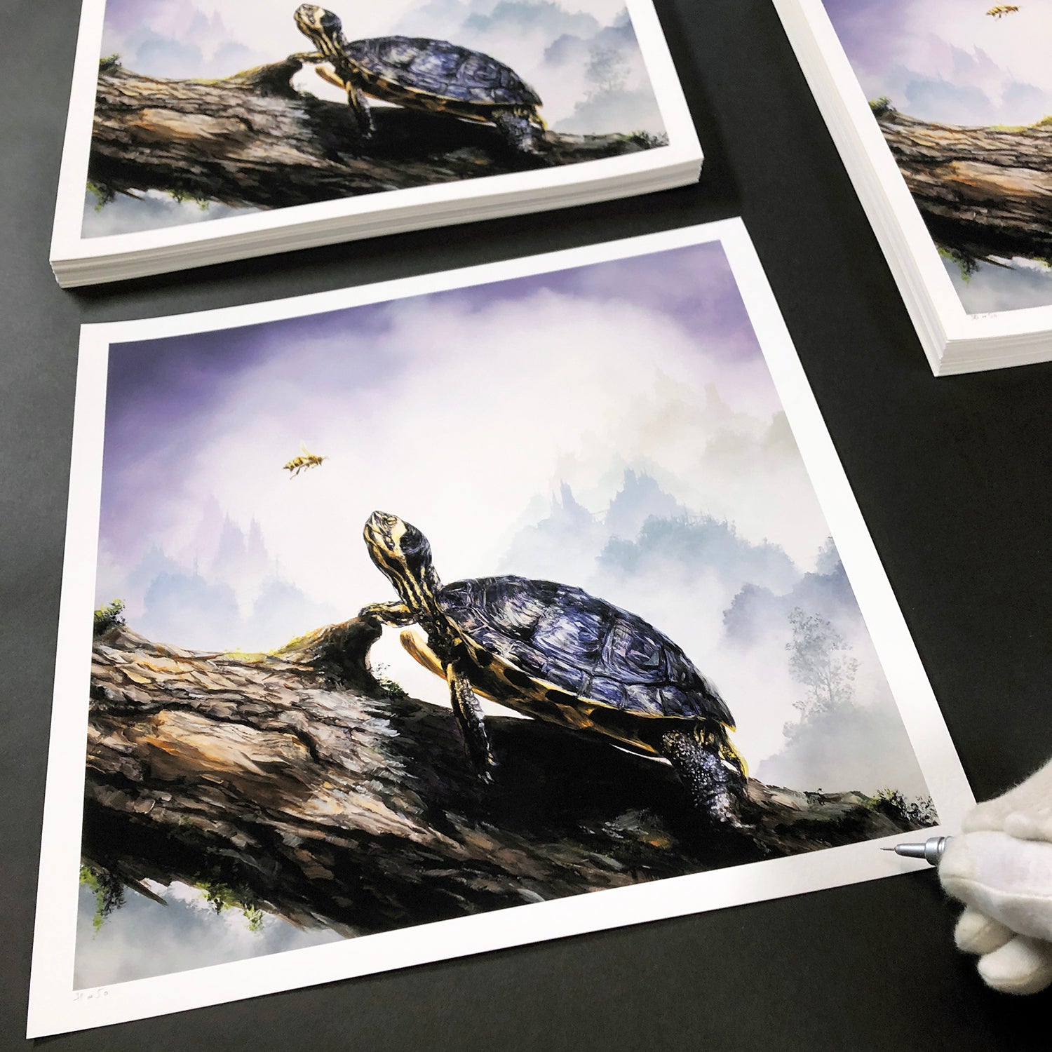 The limited edition Box Turtle & Honeybee by Brian Mashburn showcases a turtle on a log observing a bee in a misty forest, with archival pigment prints artfully arranged and adjusted by hand.