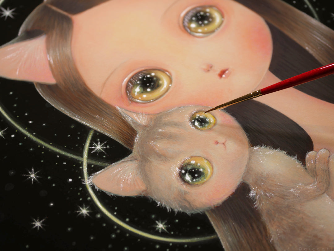 Heart by aica depicts a whimsical scene featuring a girl with cat ears and her fuzzy cat, both with glossy eyes. A paintbrush touches the cats eye, set against a starry background. This hand-embellished piece is available as a signed and numbered archival pigment print.