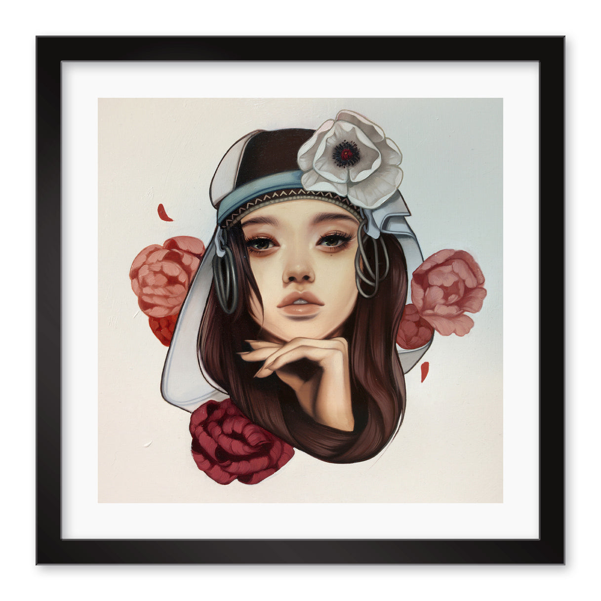 The A Prison of Comfort by Kelsey Beckett is a signed and numbered archival pigment print. It showcases a womans face with flowing hair, adorned with a white headdress and large flower. Red and pink roses frame her thoughtful gaze, all elegantly set in a black frame.