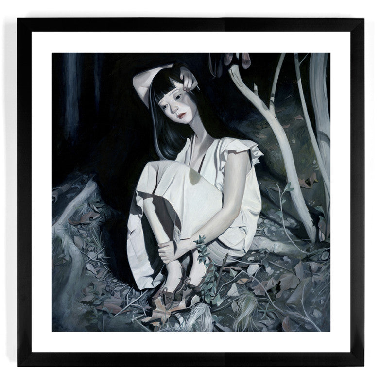The framed giclee print Bruise by Joanne Nam shows a woman with long dark hair seated on the ground in a white dress, her head resting on her hand amidst a moody, forest-like setting. This signed and numbered piece enhances its contemplative allure.