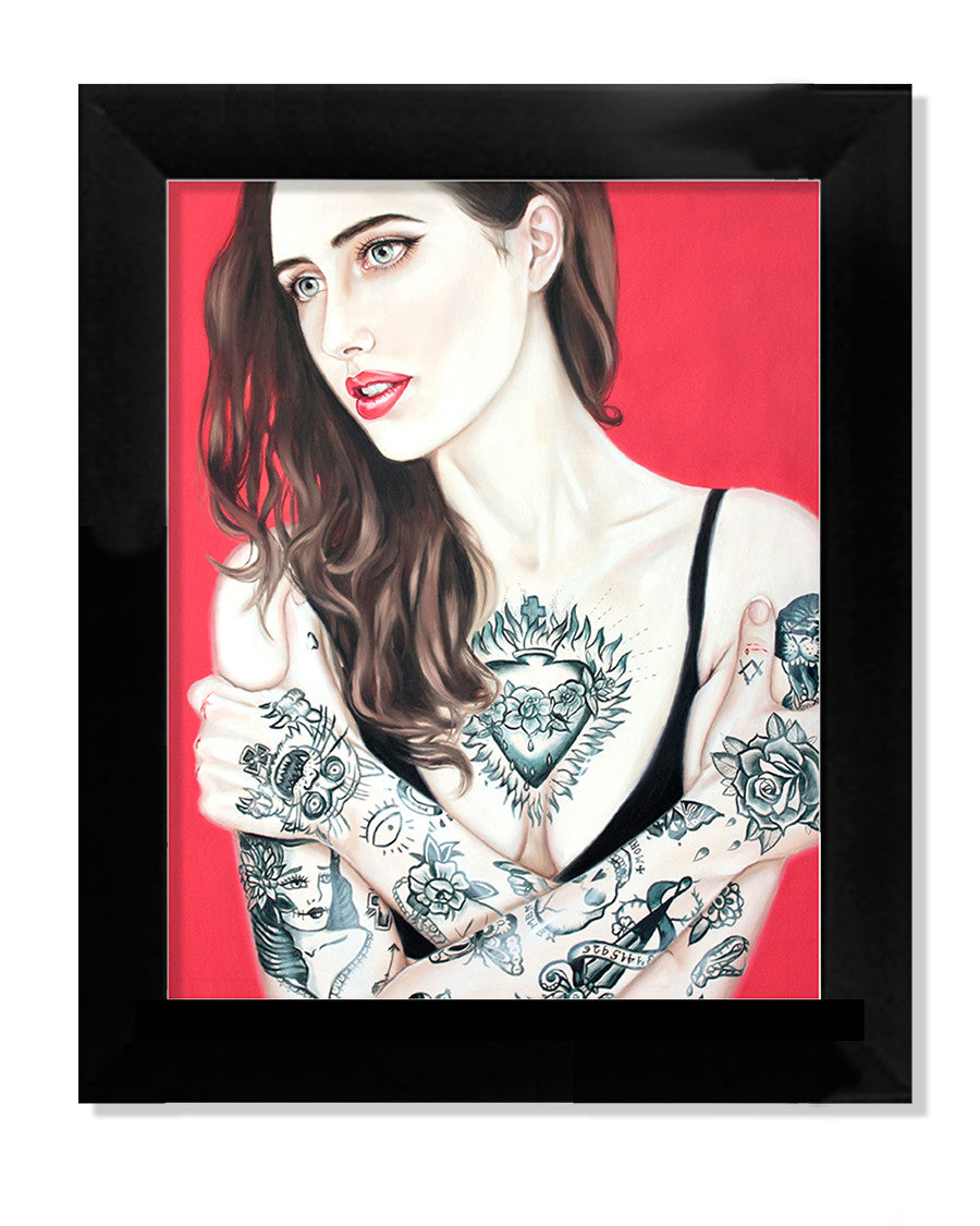The limited edition giclee print Stigma I by Crajes portrays a red-haired, tattooed woman in a black top against a vivid red background, thoughtfully gazing to the side. It exudes bold elegance.
