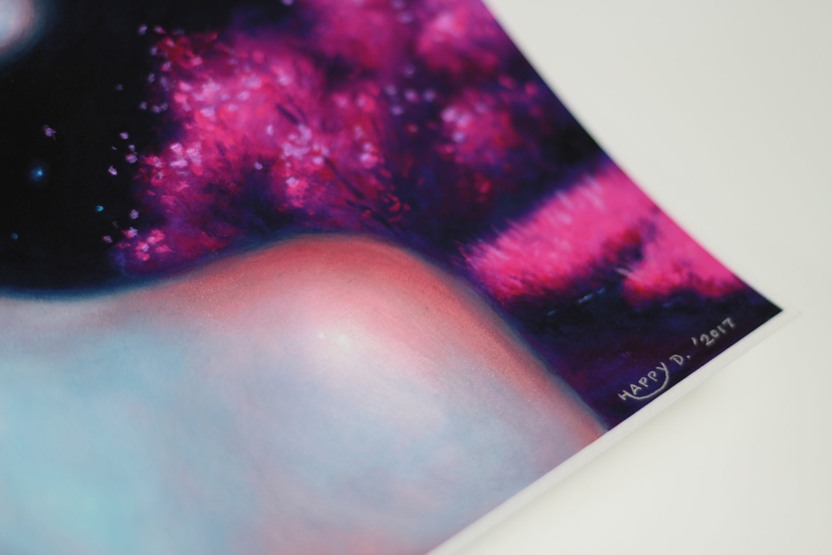A close-up of Lucid, a vibrant hand-embellished artwork by Happy D. with bright pink, blue, and purple hues. The abstract cosmic painting features swirling patterns and a glossy sheen, signed by the artist in 2021 at the bottom right corner.