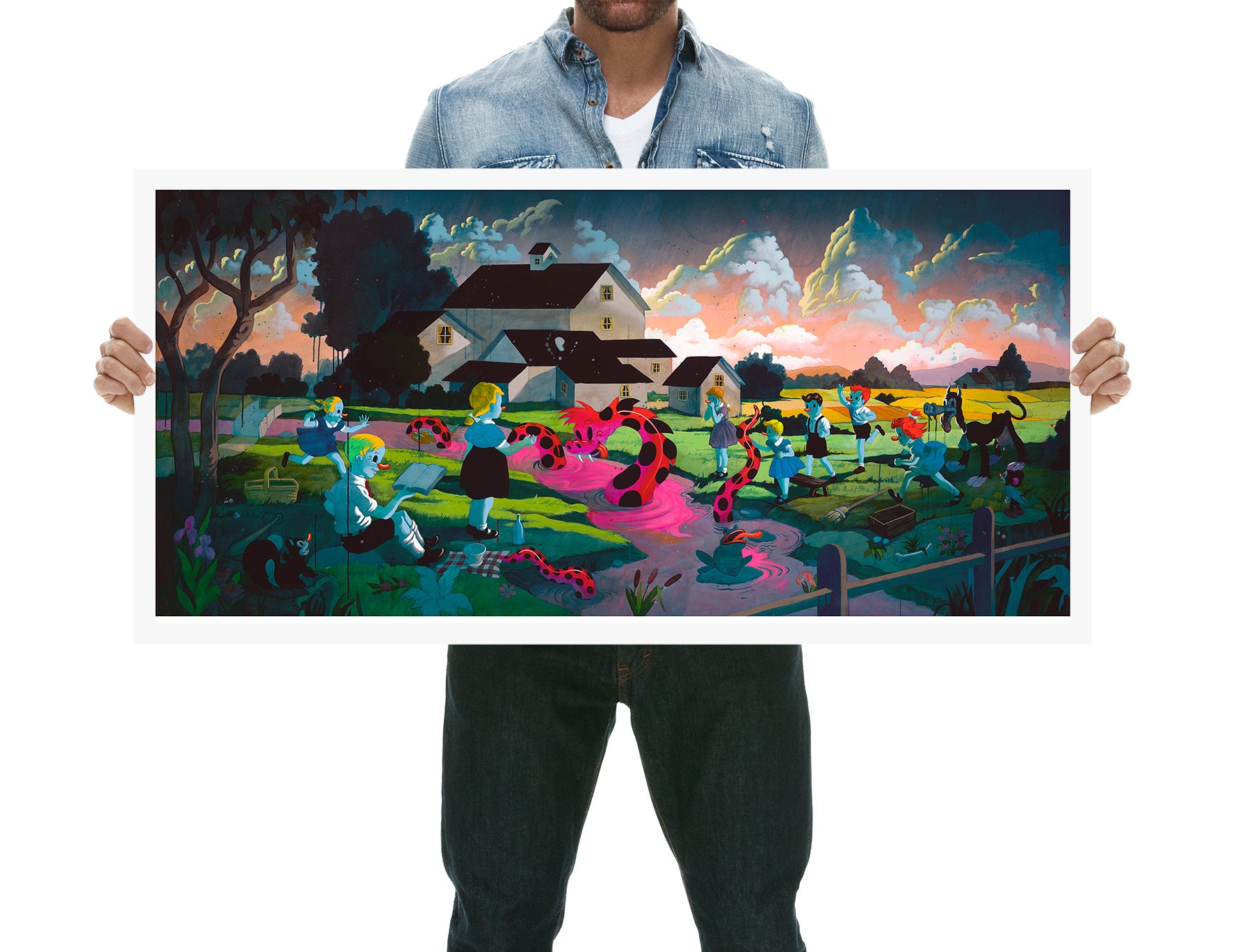 A person holds La Tierra de la Culebra, a vibrant piece by Victor Castillo, featuring a Folk Art illustration of children playing in a field with pink water, spotted cows, and a cloudy sky near a farmhouse.